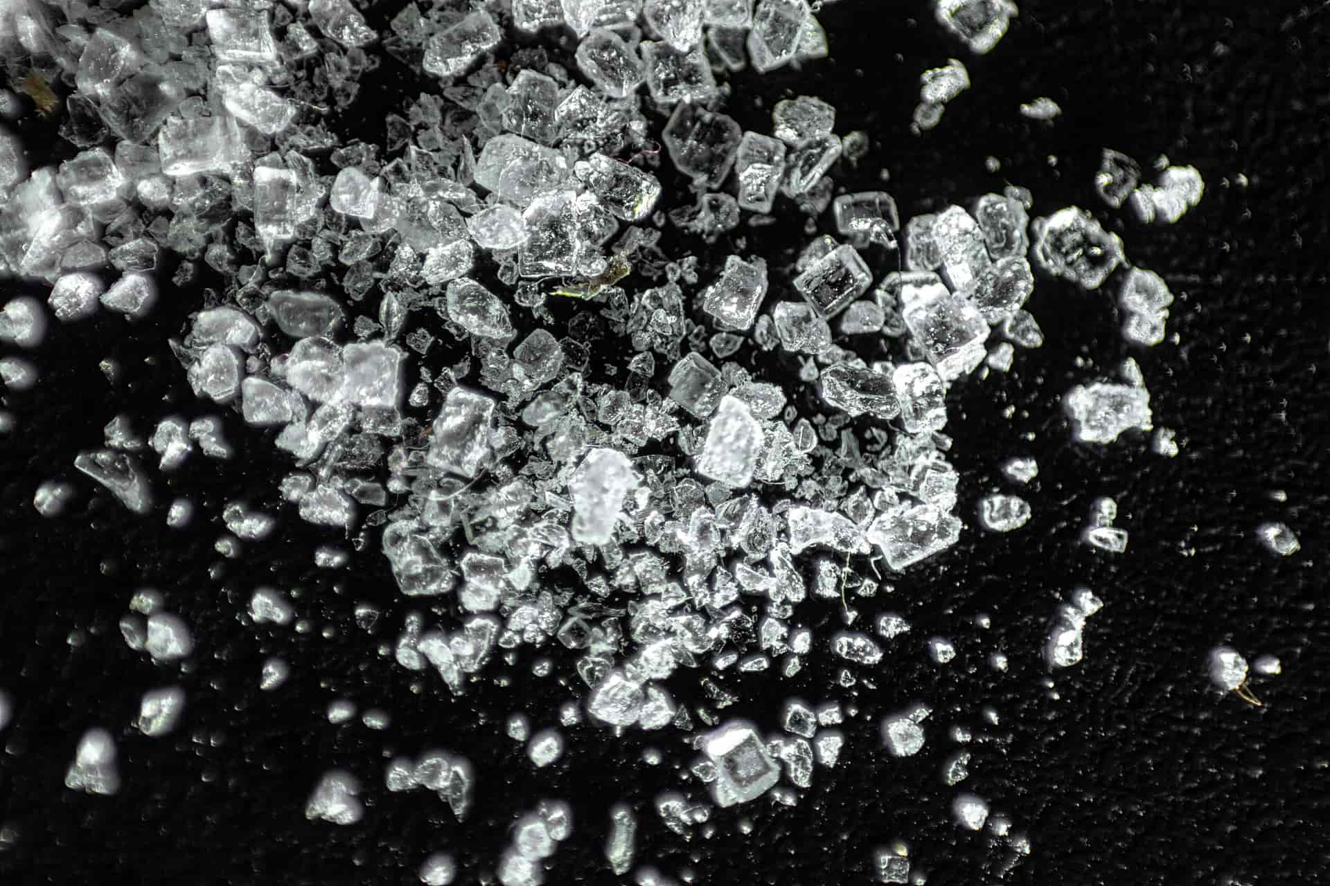 A glass filled with small, soft chewable nugget ice on a kitchen counter