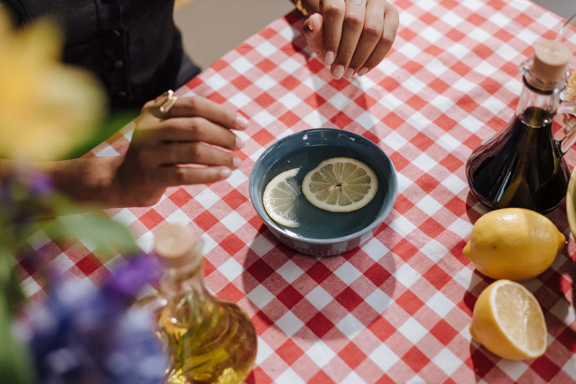 Vinegar and lemon, common household descaling acids, on a counter